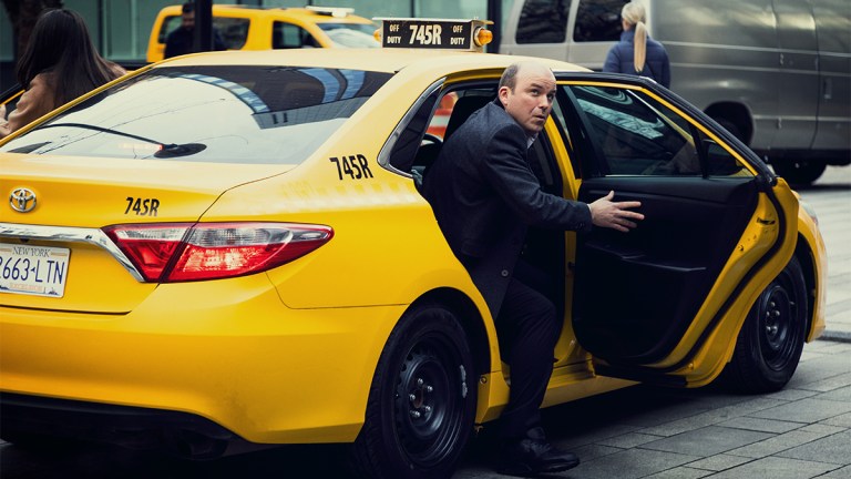 Rory Kinnear getting out of a yellow taxi cab in Netflix film Bank of Dave 2: The Loan Ranger