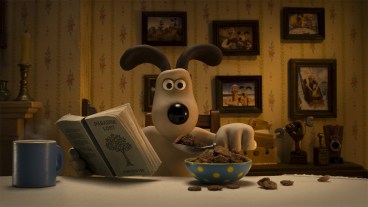 Gromit eating breakfast and reading a book in Wallace and Gromit: Vengeance Most Fowl