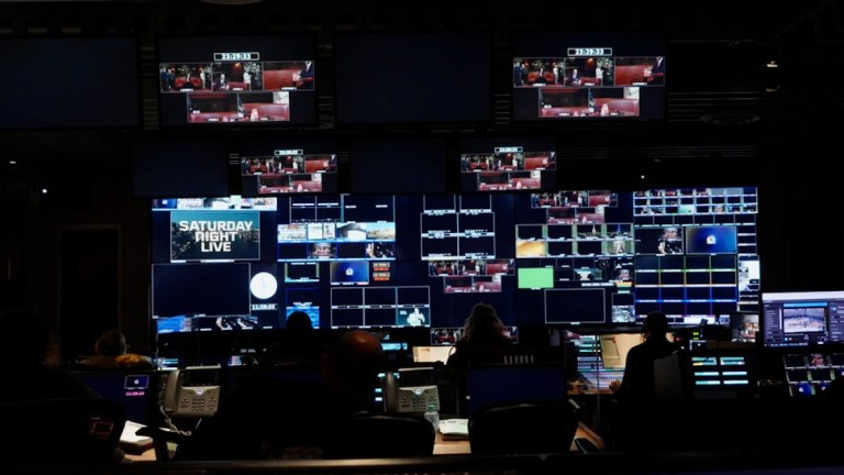 An image of the Saturday Night Live control room with many lit-up monitors.