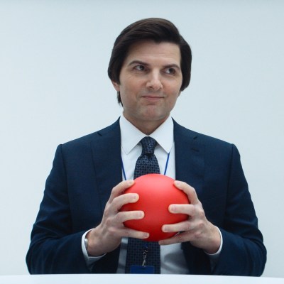 Mark S (Adam Scott) smiles and holds a red ball in Severance season 2.